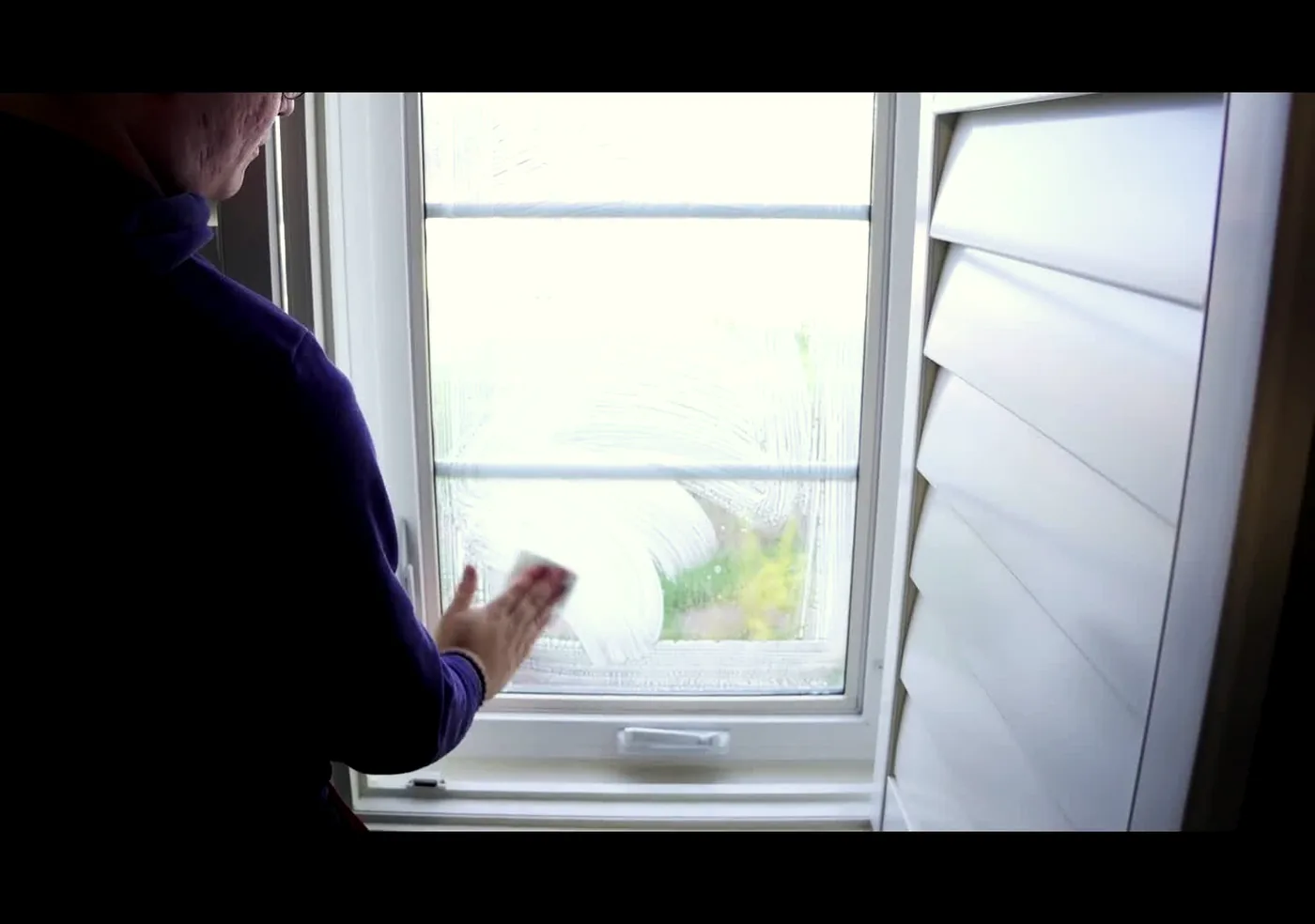 Window film behind plantation shutters in an Ogden home
